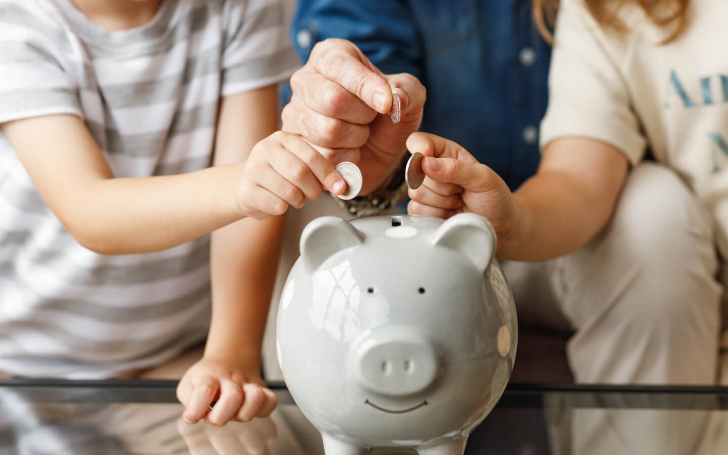 Grandfather and grandchildren saving money