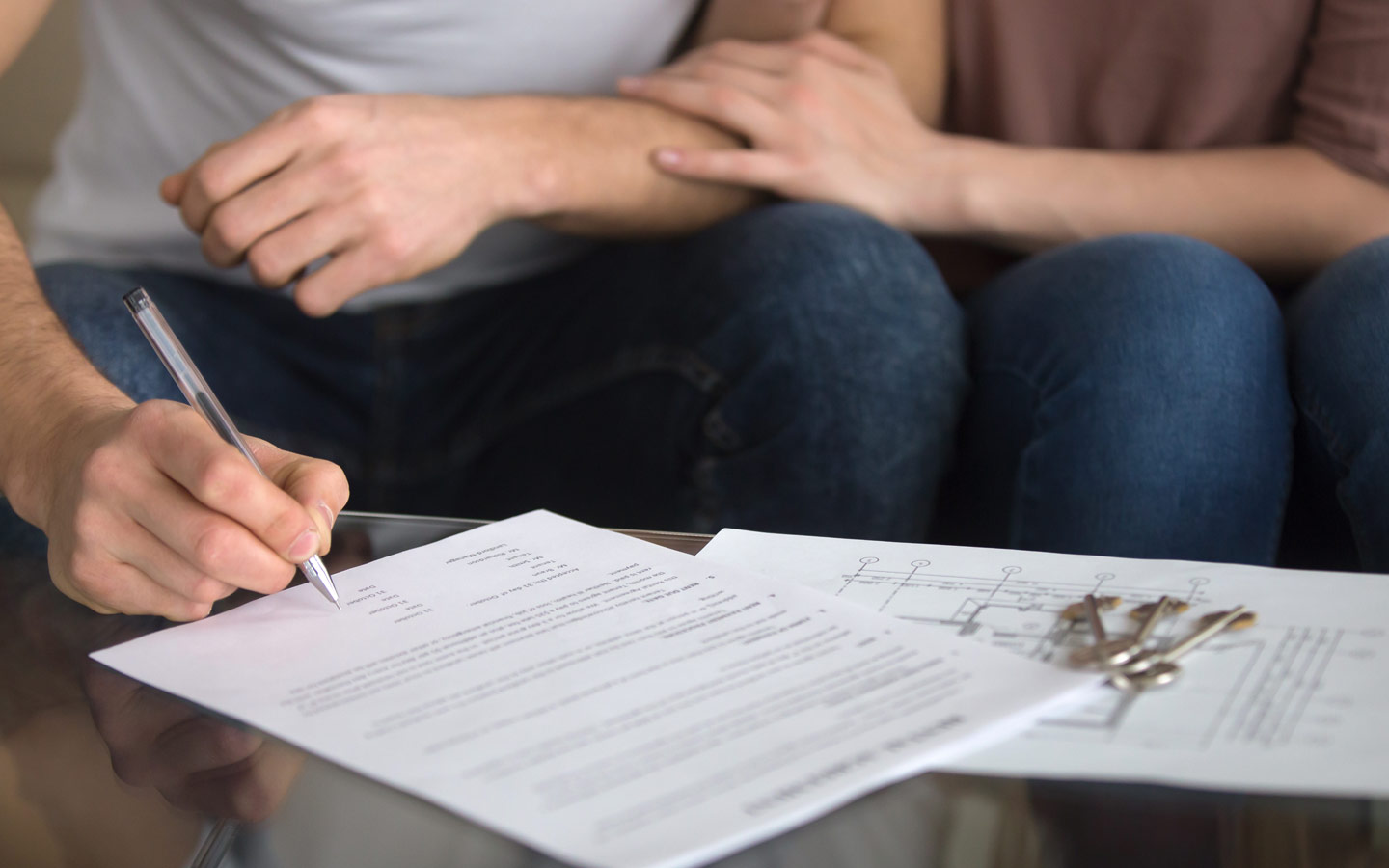 Couple signing home loan documents